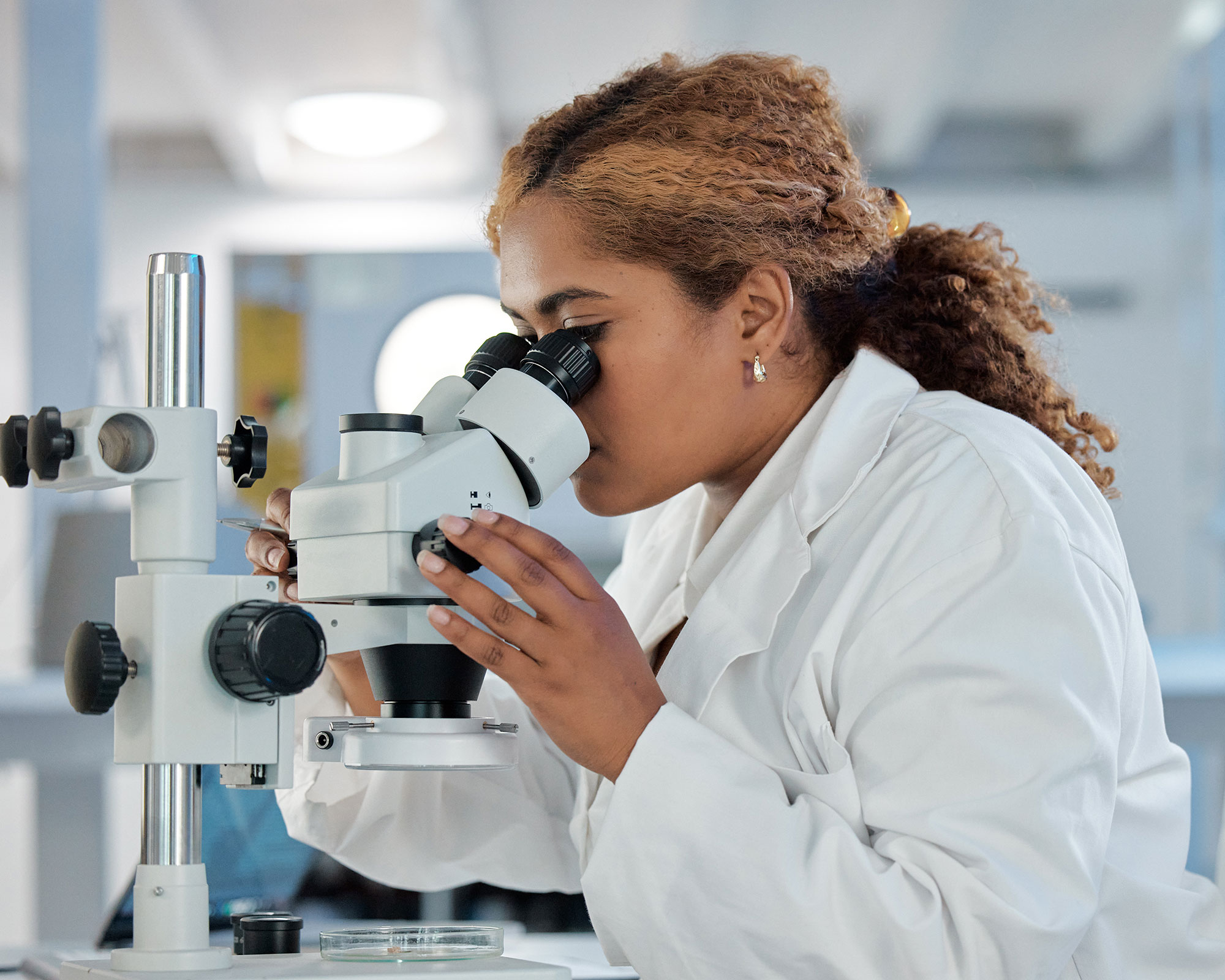 Photo of a researcher looking through a microscope.
